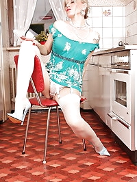 Housewife Alina in stockongs and high heels posing on the..