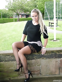Melanie is outdoors showing off her nylon covered legs and..